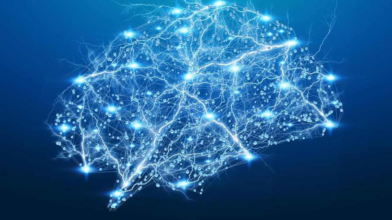 A wireframe of a brain glowing against a darker background. Lighted nodes are connected by arcs of electricity.